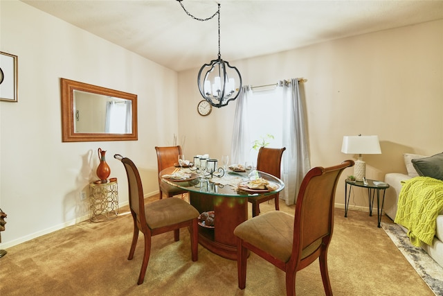 dining area featuring light carpet and a notable chandelier