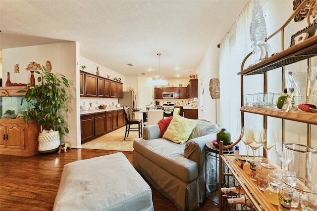 living room with wood-type flooring and a notable chandelier