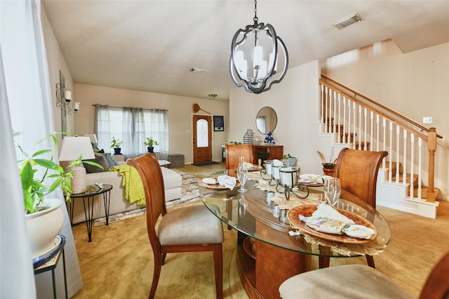 carpeted dining room with a notable chandelier