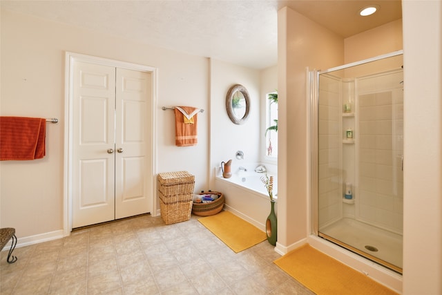 bathroom featuring shower with separate bathtub