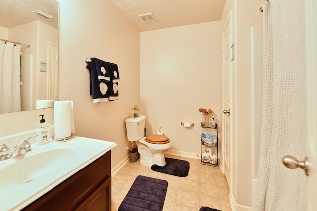 full bathroom featuring shower / tub combo with curtain, tile patterned flooring, vanity, and toilet