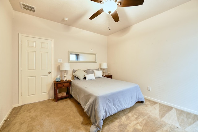 bedroom featuring baseboards, visible vents, light carpet, and ceiling fan