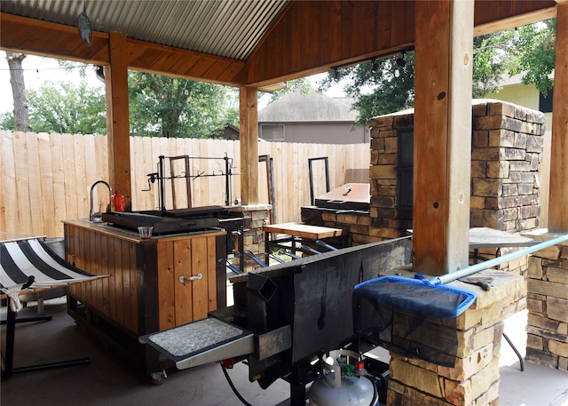 view of patio featuring area for grilling and an outdoor bar