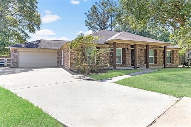 ranch-style house featuring a front yard and a garage