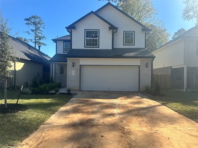 view of front property featuring a garage and a front yard