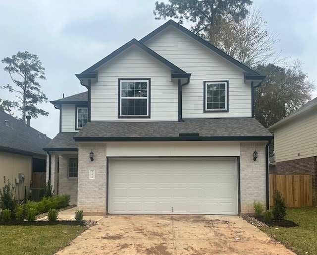 view of property featuring a garage and cooling unit