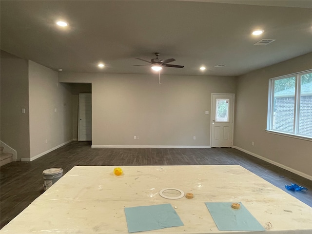 unfurnished room featuring ceiling fan and dark wood-type flooring