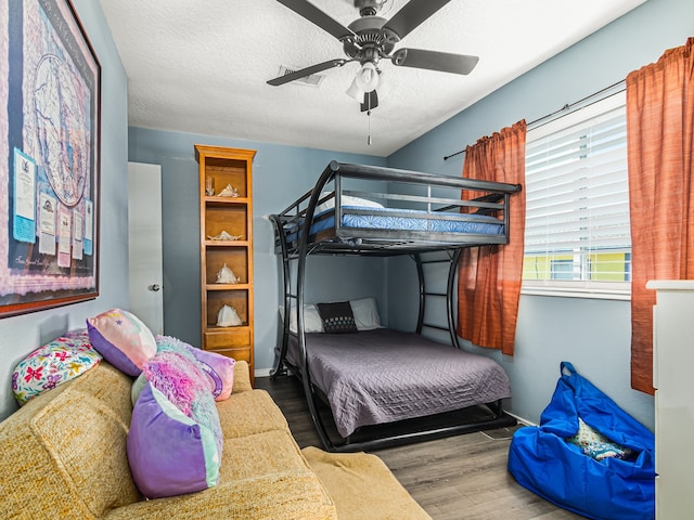 bedroom featuring a textured ceiling, hardwood / wood-style flooring, and ceiling fan