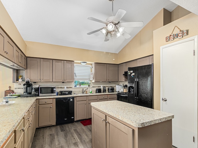 kitchen with lofted ceiling, dark wood-type flooring, black appliances, sink, and ceiling fan