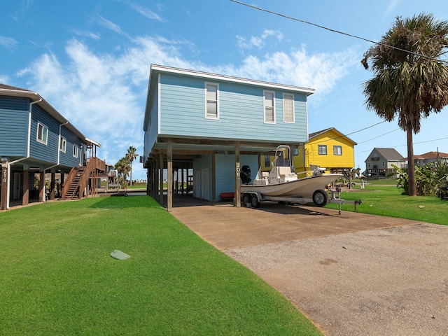 view of front facade featuring a carport and a front yard