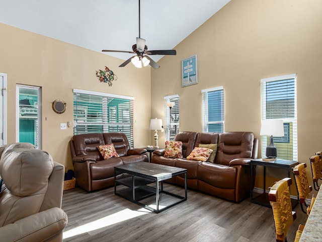 living room with ceiling fan, high vaulted ceiling, and hardwood / wood-style floors