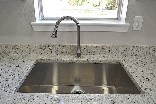 interior details with light stone counters and sink