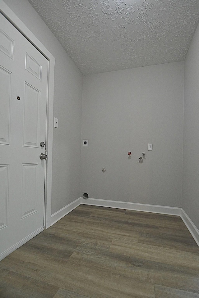 laundry area featuring hookup for an electric dryer, gas dryer hookup, wood-type flooring, and a textured ceiling