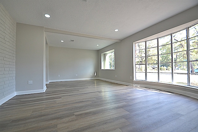 empty room featuring hardwood / wood-style flooring and a textured ceiling