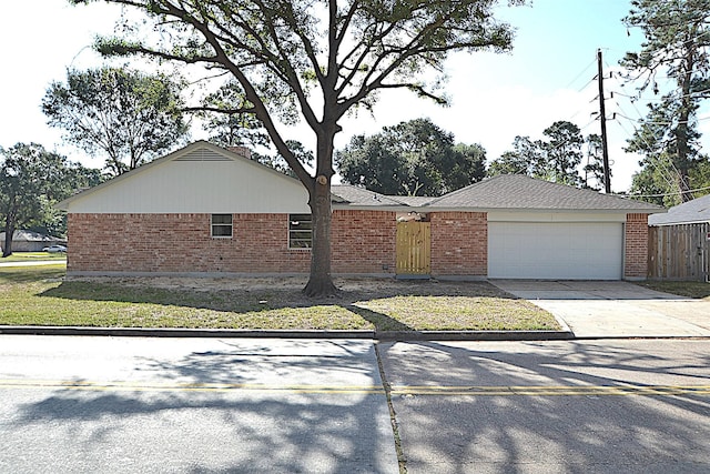 single story home featuring a front yard and a garage