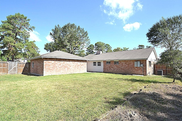 back of house featuring a yard and cooling unit