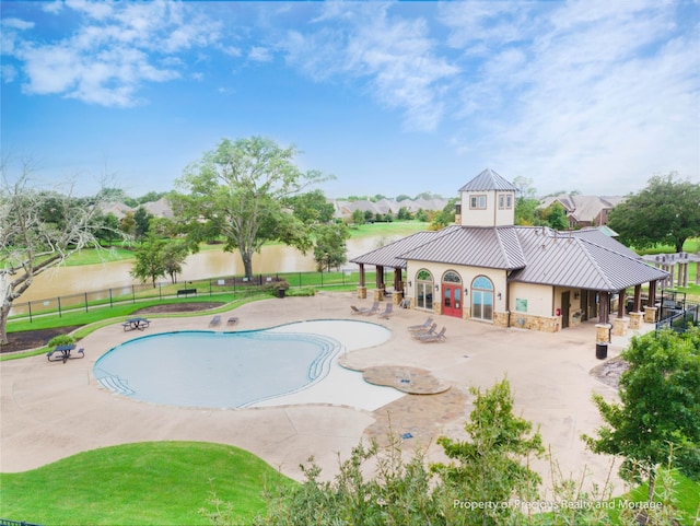 view of pool with a water view and a patio area