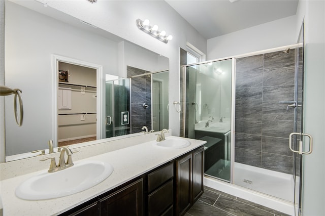 bathroom featuring vanity and a shower with door