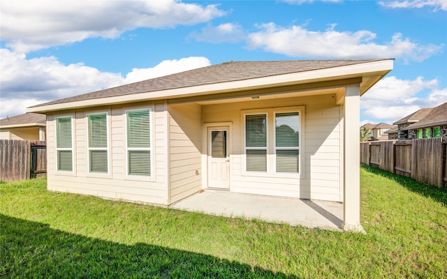 rear view of property with a patio area and a yard