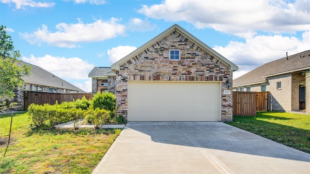 view of front of home featuring a front yard and a garage