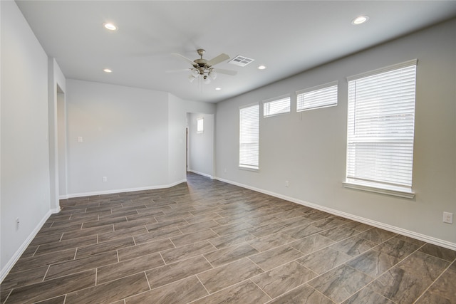 unfurnished room featuring ceiling fan and a healthy amount of sunlight