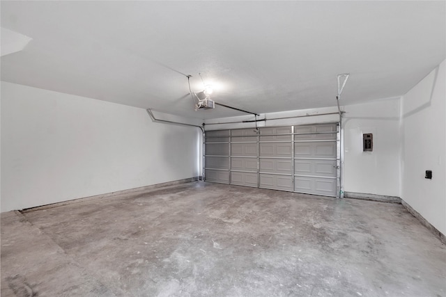 garage with a garage door opener and electric panel