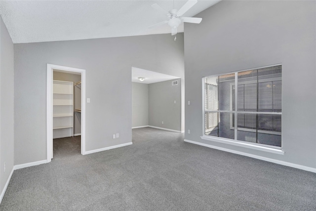 interior space with ceiling fan, carpet flooring, and high vaulted ceiling