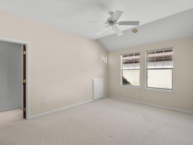 unfurnished room featuring light carpet, ceiling fan, and vaulted ceiling