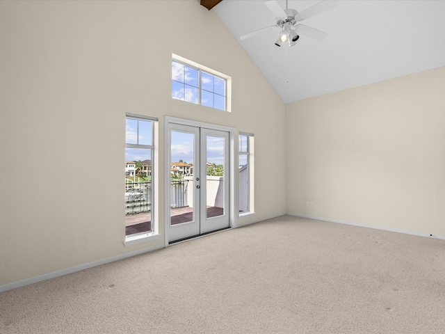 spare room featuring high vaulted ceiling, ceiling fan, french doors, and carpet