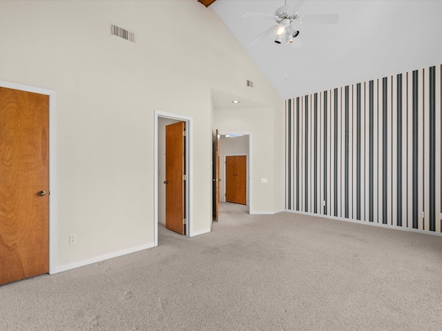 unfurnished room with light carpet, high vaulted ceiling, and ceiling fan