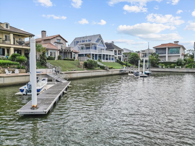 dock area featuring a water view and a balcony