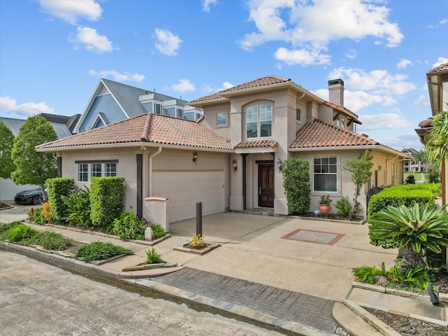 mediterranean / spanish home featuring a garage