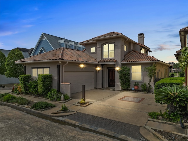 mediterranean / spanish home with a garage