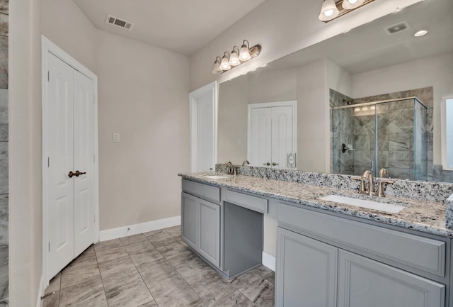 bathroom with walk in shower and vanity