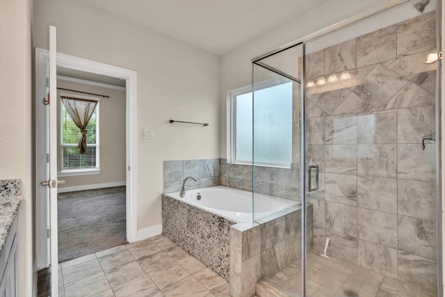 bathroom featuring vanity, tile patterned flooring, and separate shower and tub