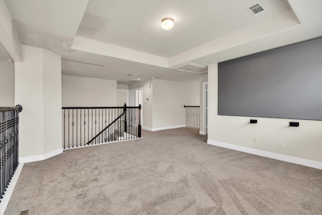 home theater room with a tray ceiling and carpet floors