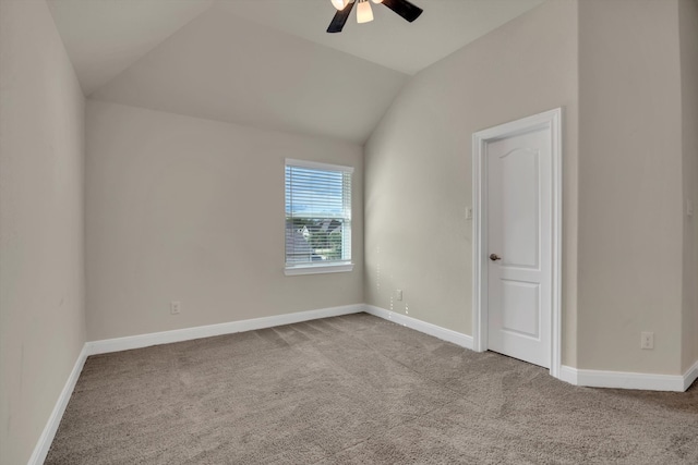 empty room with ceiling fan, light colored carpet, and lofted ceiling