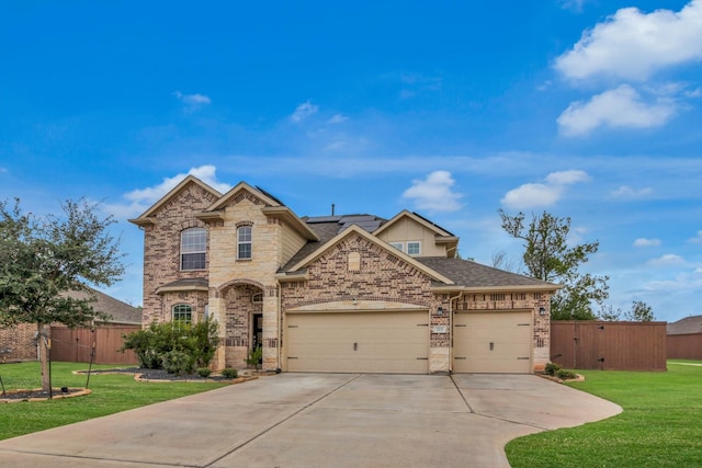 view of front of home with a garage and a front lawn