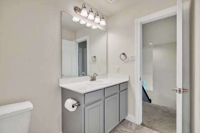 bathroom featuring vanity and toilet