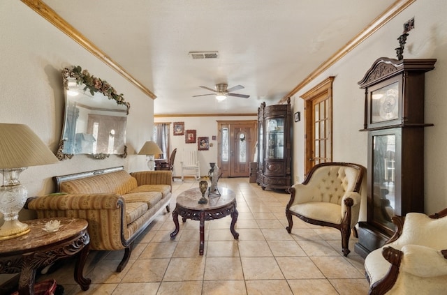 tiled living room with ceiling fan and ornamental molding