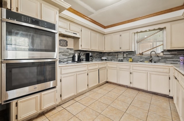 kitchen with backsplash, double oven, and light tile patterned floors