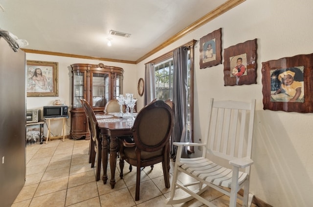 tiled dining space featuring ornamental molding