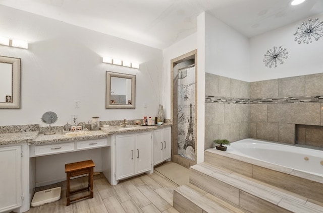 bathroom featuring hardwood / wood-style flooring, vanity, and separate shower and tub