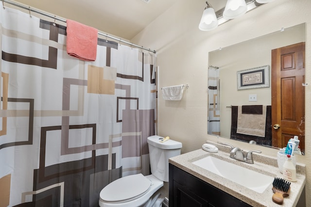 bathroom featuring vanity, toilet, and a shower with shower curtain