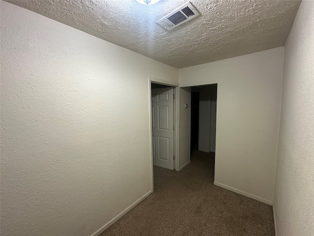 interior space featuring carpet and a textured ceiling