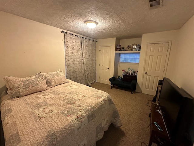 bedroom featuring carpet and a textured ceiling