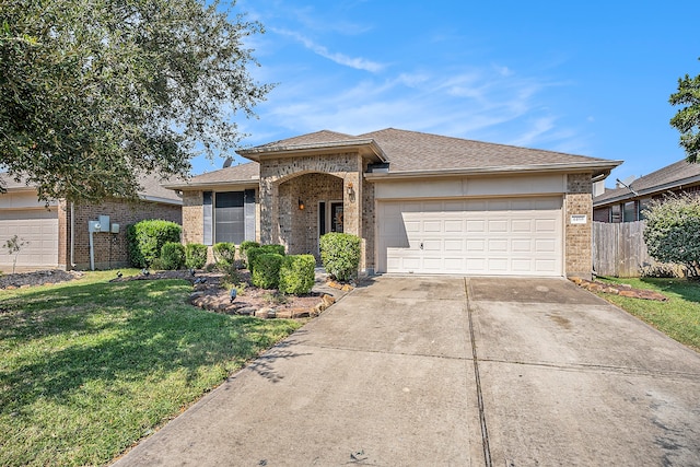 ranch-style house featuring a front lawn and a garage