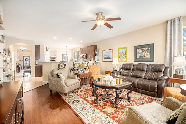 living room featuring dark hardwood / wood-style floors and ceiling fan