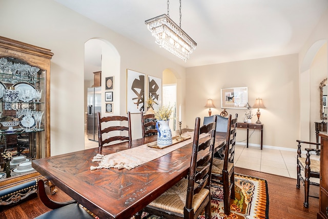 dining room featuring an inviting chandelier and hardwood / wood-style flooring