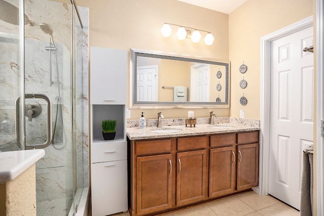 bathroom featuring vanity, tile patterned flooring, and walk in shower